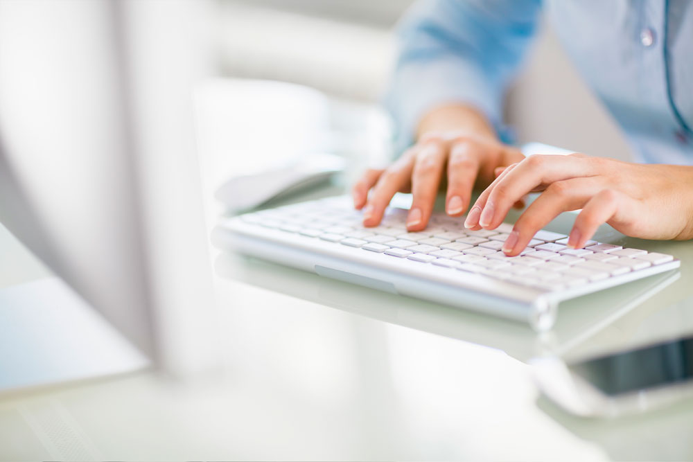 Person typing on keyboard.