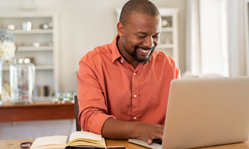 Man typing on laptop.