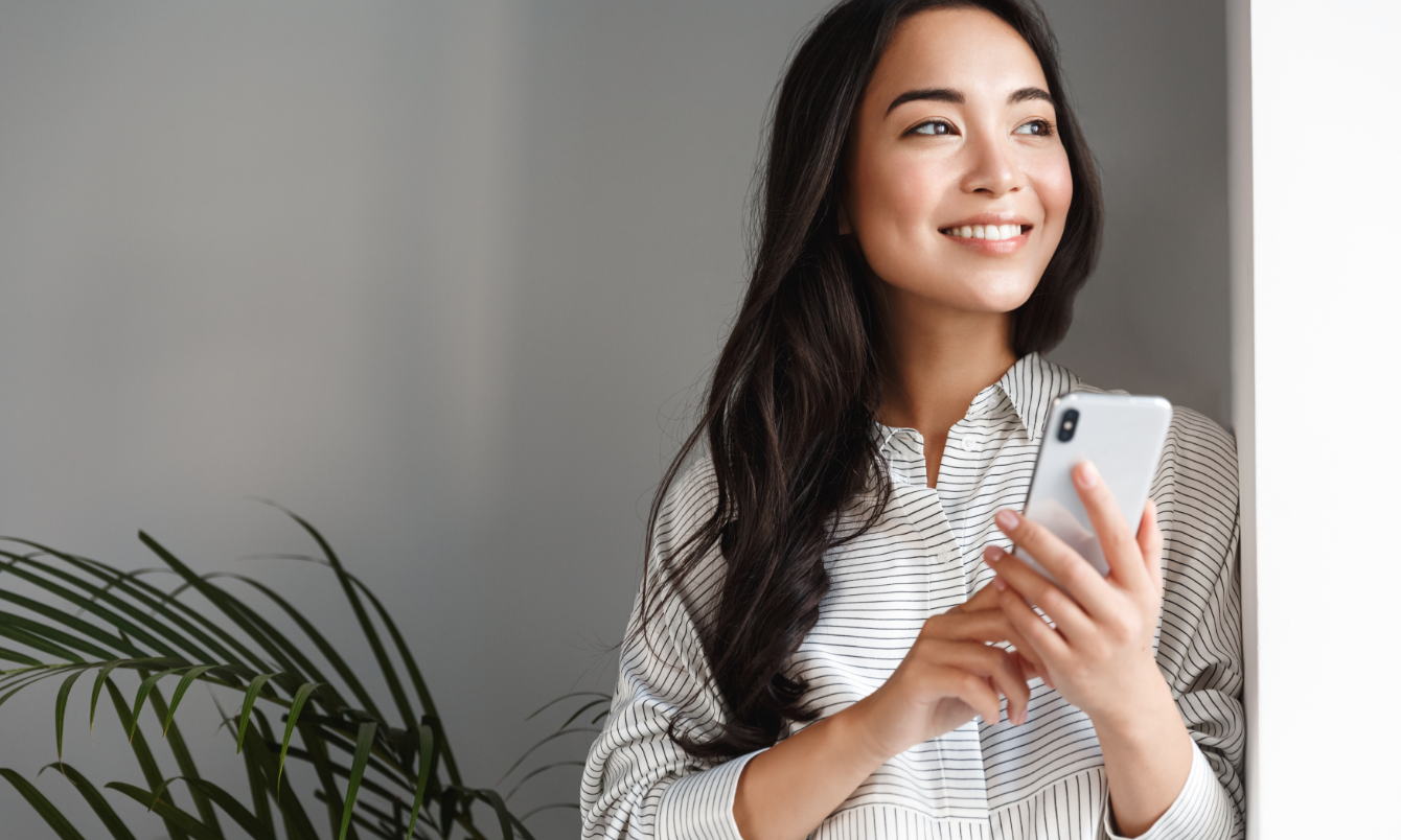 Person holding phone and looking off.