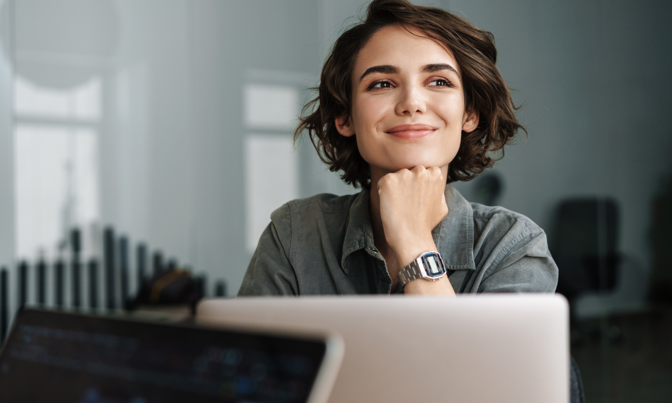 Female staring past laptop