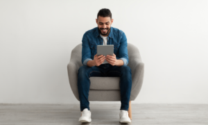 Man smiling at tablet