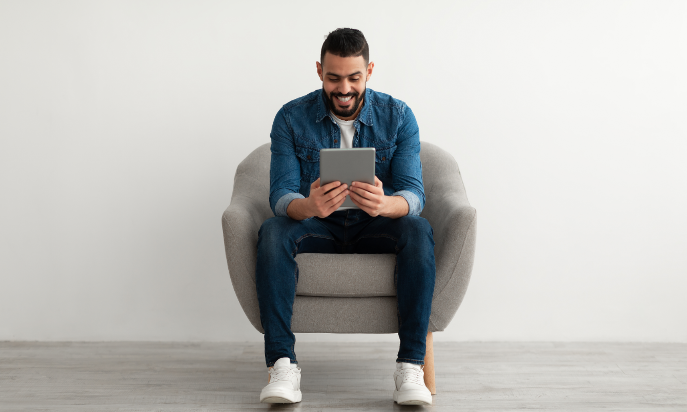 Man smiling at tablet