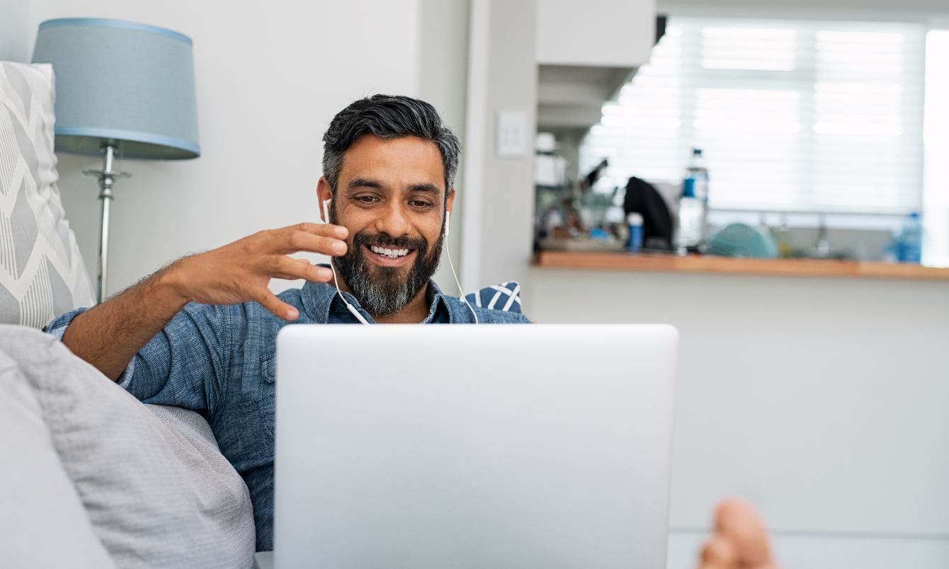 Male talking into laptop