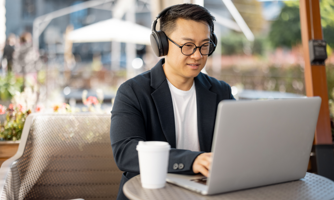 Man in headphones looking at laptop.