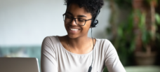 Woman smiling at laptop.