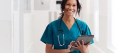 Nurse accessing digital resources on a tablet