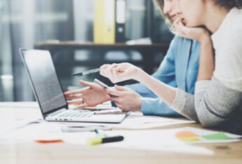 two colleagues working on computer