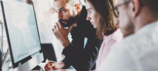 Group of people around desktop