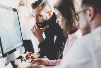 Group of people around desktop