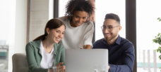 Group of people looking at laptop