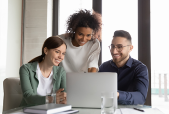 Group of people looking at laptop