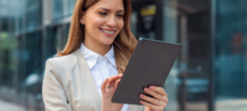 Female smiling at tablet