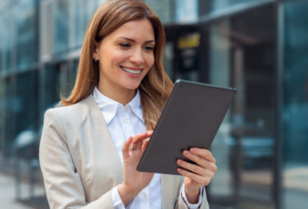 Female smiling at tablet