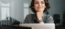 Female staring past laptop