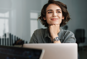 Female staring past laptop