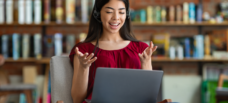 Female talking into laptop
