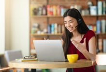 Female talking into laptop