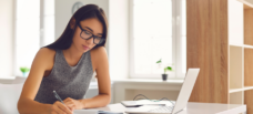 Female writing next to laptop_Blog