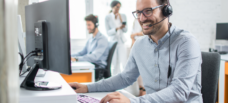 Man smiling at laptop.
