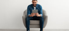 Man smiling at tablet