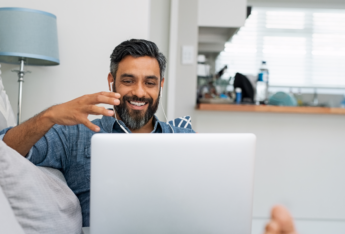 Male talking into laptop