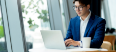 Man typing on laptop.