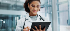 Doctor at hospital with tech. Using tablet to engage with digital content.