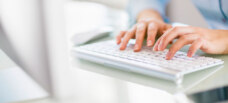 Person typing on keyboard.