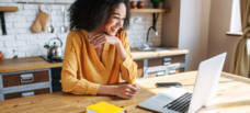 Woman looking at laptop.